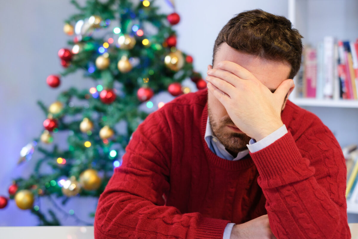Sad man feeling negative emotions and alone during christmas